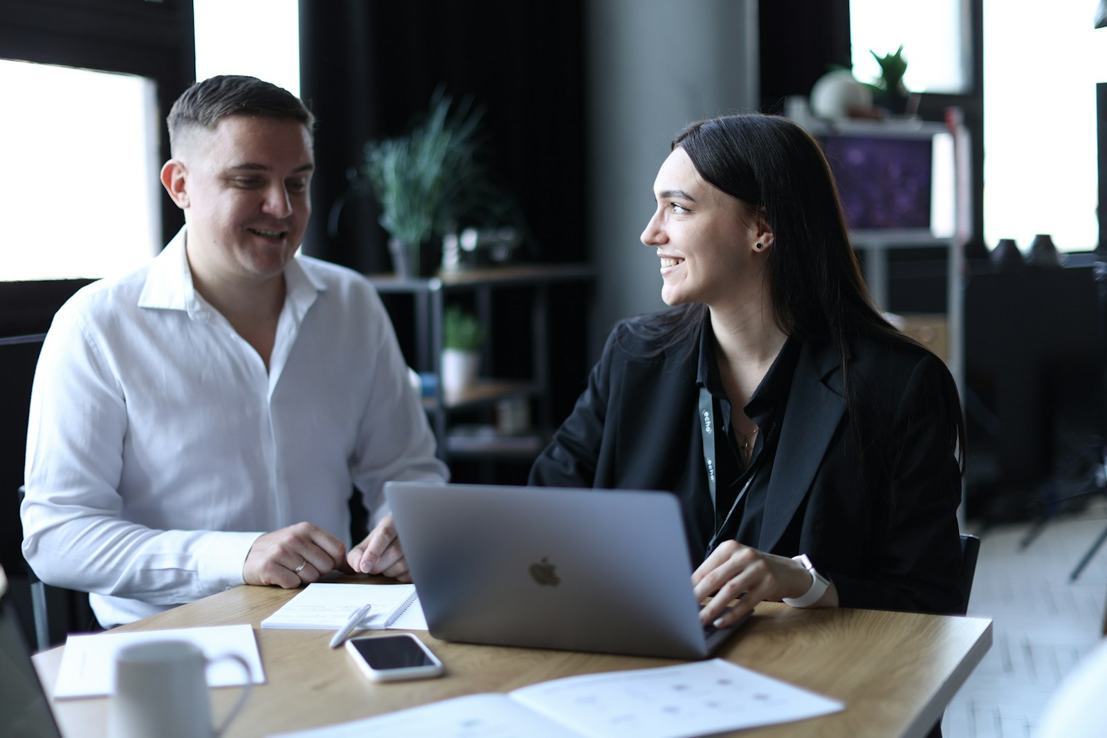 Two people reviewing casework at a laptop